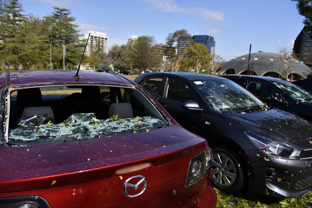Hail damaged cars are seen parked outside the National Film and Sound Archive of Australia in Canberra, Monday, January 20, 2020. (AAP Image/Mick Tsikas)