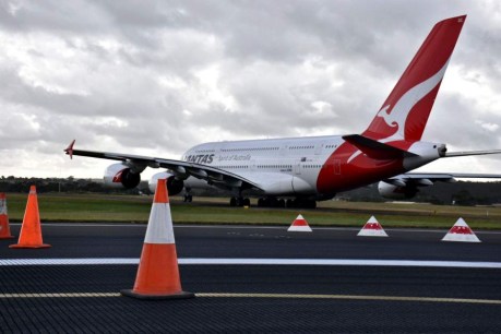 Qantas slashes flights to Asia, warns of $150m earnings risk
