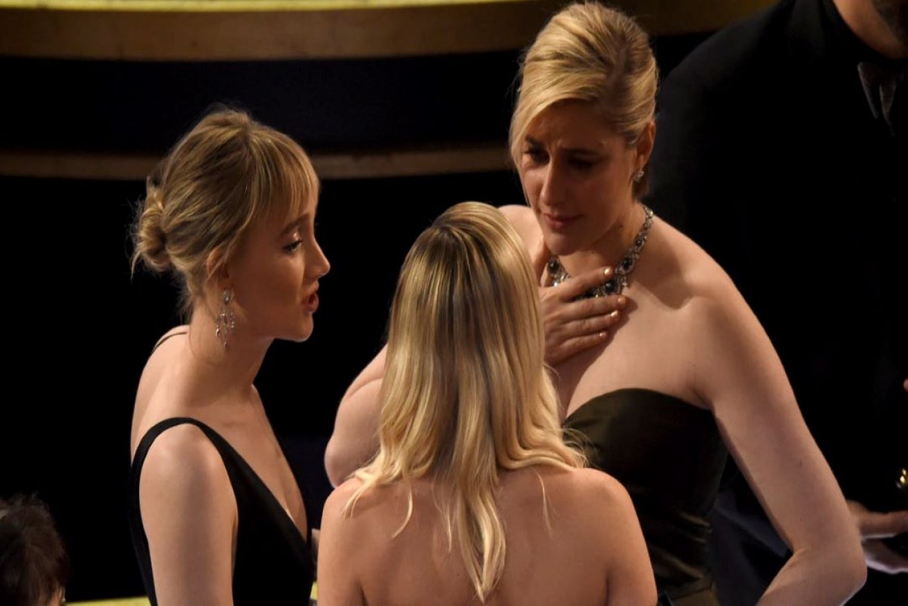 Saoirse Ronan, from left, Margot Robbie and Greta Gerwig are seen in the audience at the Oscars on Feb. 9, 2020, at the Dolby Theatre in Los Angeles. (AP Photo/Chris Pizzello)