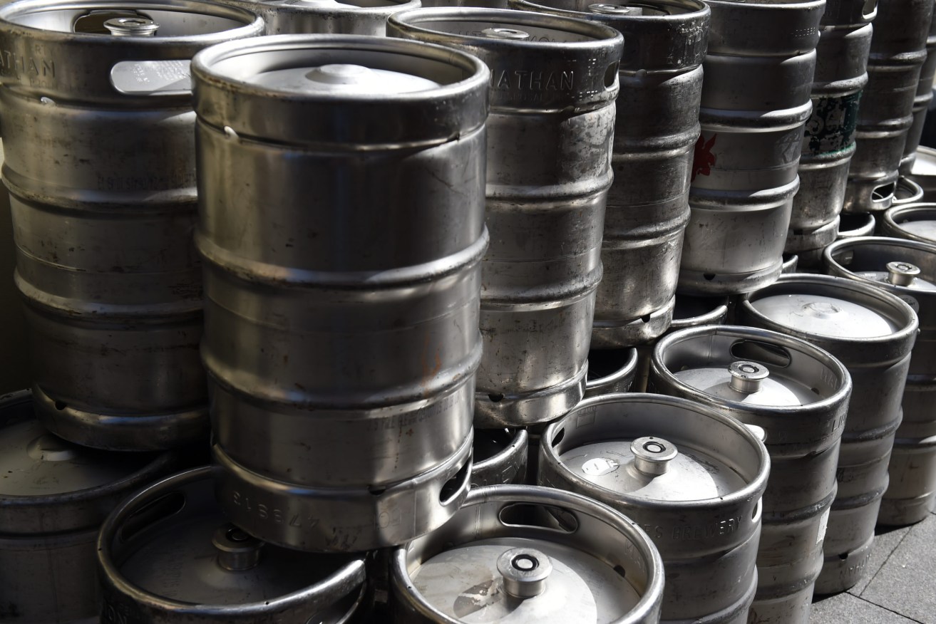 Empty beer kegs wait for collection outside of a pub in Sydney. (AAP Image/Paul Miller) NO ARCHIVING