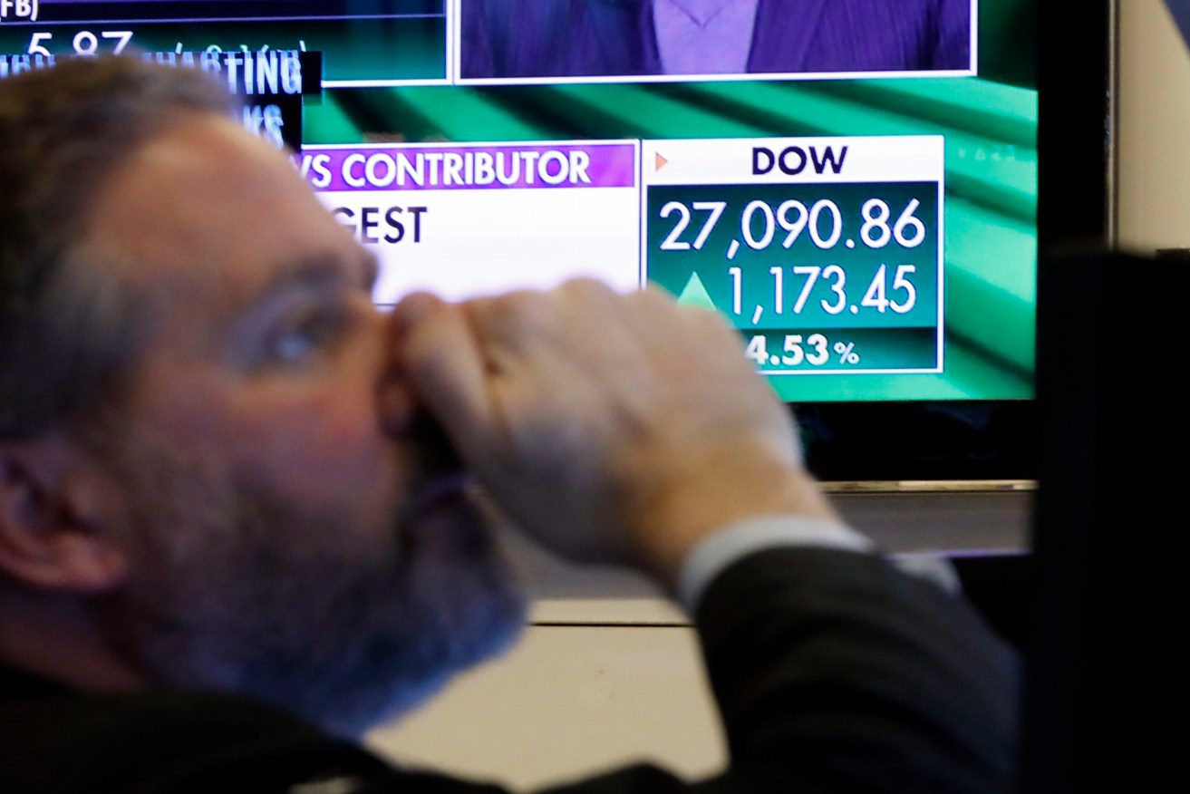 A television screen on the floor of the New York Stock Exchange shows the closing number or the DJIA, Wednesday, March 4, 2020. The Dow Jones Industrial Average soared more than 1,100 points, or 4.5%, on hopes for more stimulus measures from around the globe to fight the virus outbreak. (AP Photo/Richard Drew)