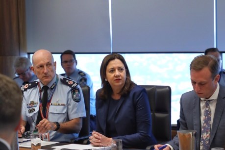 Even inside Queensland’s ‘war room’,  people are now keeping their distance