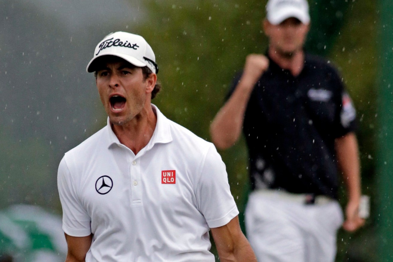Adam Scott, of Australia, celebrates after a birdie putt on the 18th green during the fourth round of the Masters golf tournament Sunday, April 14, 2013, in Augusta, Ga. (AP Photo/Darron Cummings)