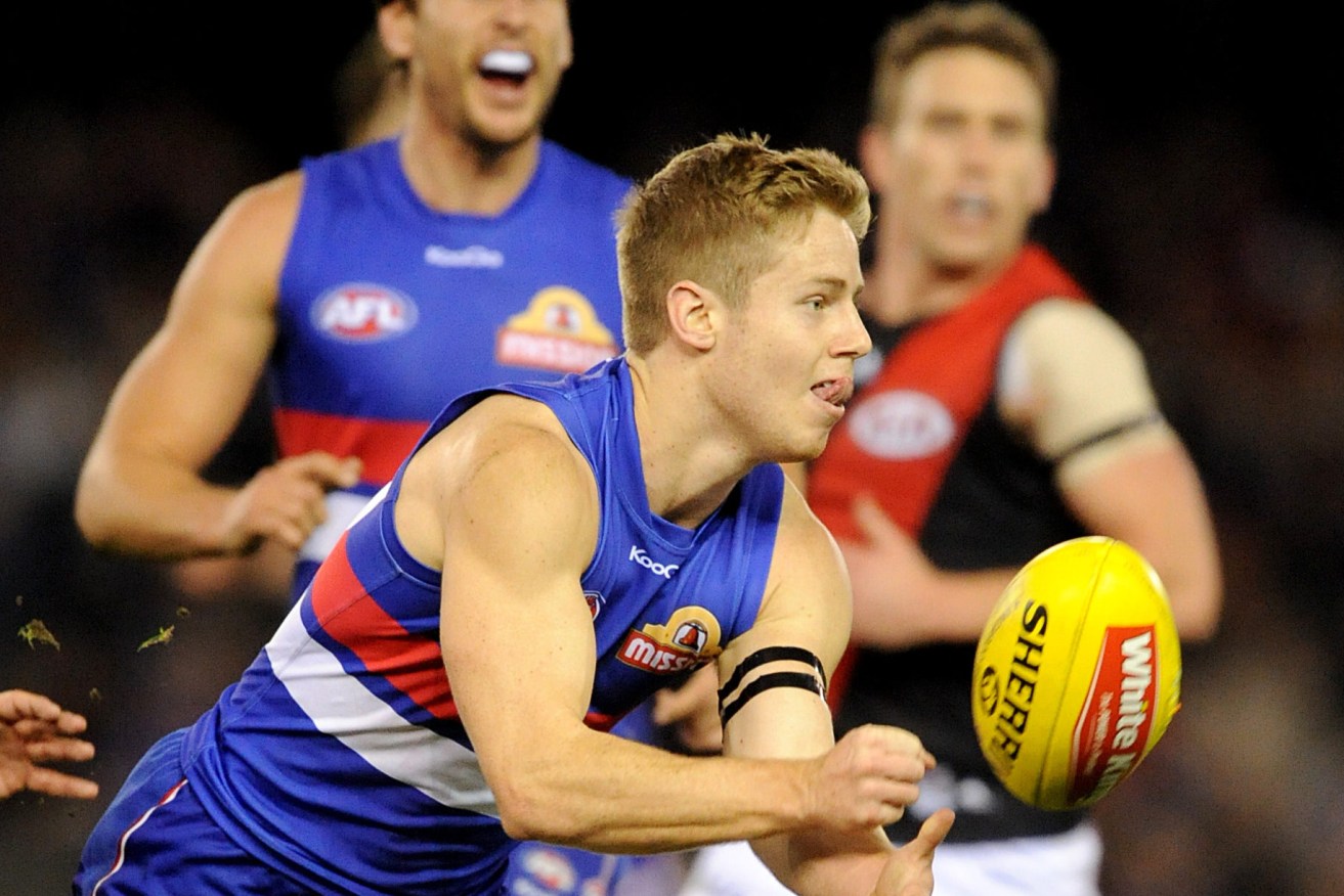 Lachlan Hunter of the Western Bulldogs runs with the ball, during the Round 18 AFL match between the Western Bulldogs and Essendon Bombers (Photo: AAP Image/Joe Castro)