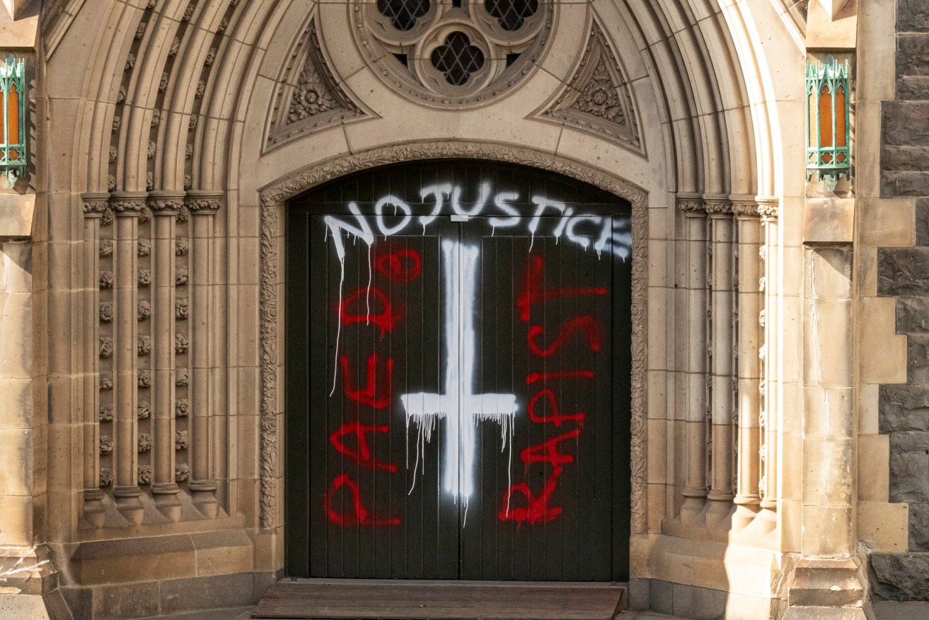 Graffiti is seen at St Patricks Cathedral in Melbourne, Australia, Wednesday, April 8, 2020. (AAP Image/Daniel Pockett) NO ARCHIVING