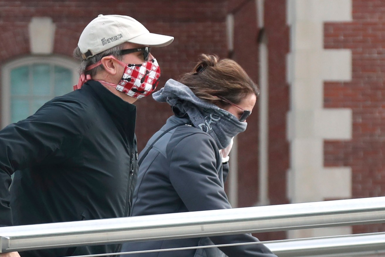 Pedestrians wearing masks due to the coronavirus outbreak in Boston. (Photo: AP Photo/Elise Amendola)