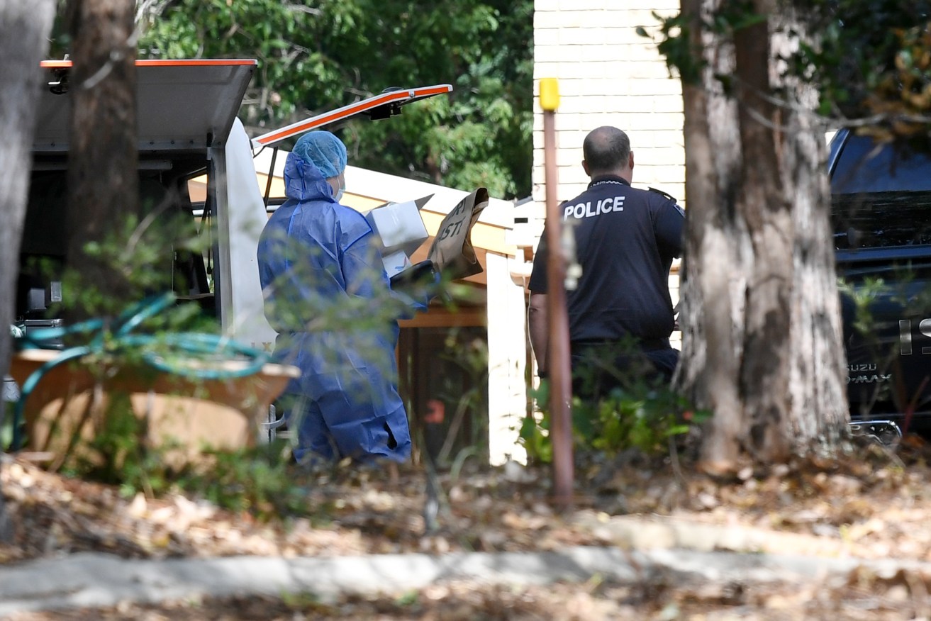 A police forensic officer (left) tends to the scene of the suspected double murder of Frank and Loris Puglia in Joyner in Brisbane's north, on Monday, May 18, 2020. Their 31 year-old son Chris Puglia has been arrested in Sydney and charged with their murders. (Photo: AAP Image/Dan Peled)