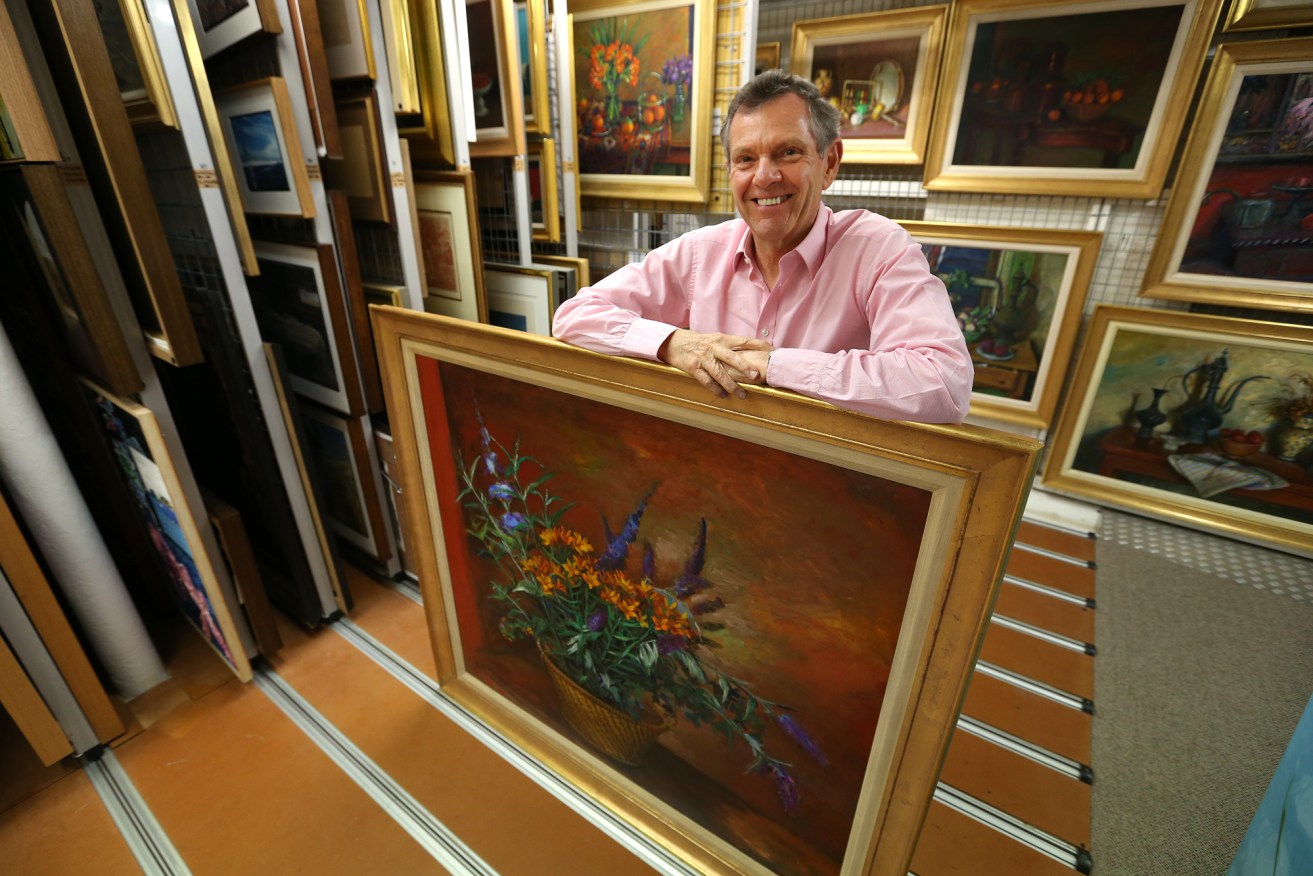 Philip Bacon with one of Margaret Olley's largest ever still-life paintings, "Flowers in a Basket", which featured in a recent exhibition at the gallery.