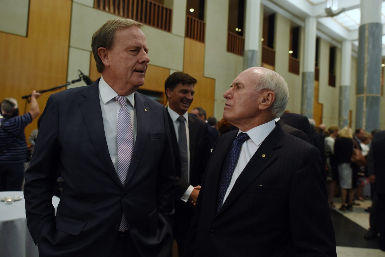 Former Australian prime pinister John Howard (right) speaks to former Australian treasurer Peter Costello - the two proponents of Australia's Goods and Services Tax. (Photo: AAP Image/Lukas Coch) 