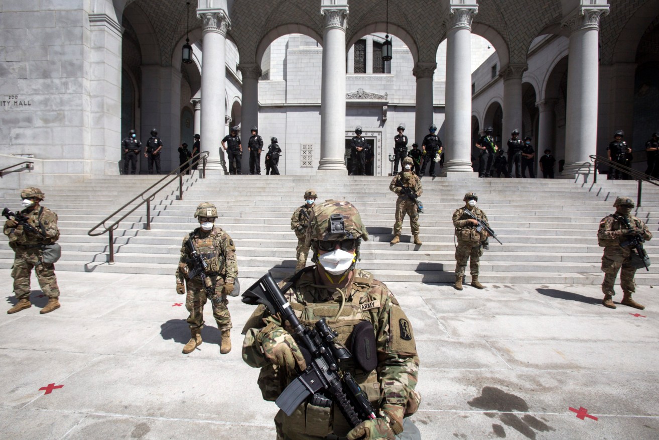 Members of California National Guard stand guard outside the City Hall, Sunday, May 31, 2020, in Los Angeles. The National Guard is patrolling Los Angeles as the city begins cleaning up following a night of violent protests against police brutality. (Photo: AP Photo/Ringo H.W. Chiu)