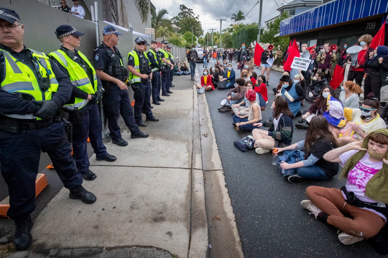 Protesters gather to support asylum seekers detained at the Kangaroo Point Central Hotel in Brisbane, Sunday, June 28, 2020. (AAP Image/Glenn Hunt)