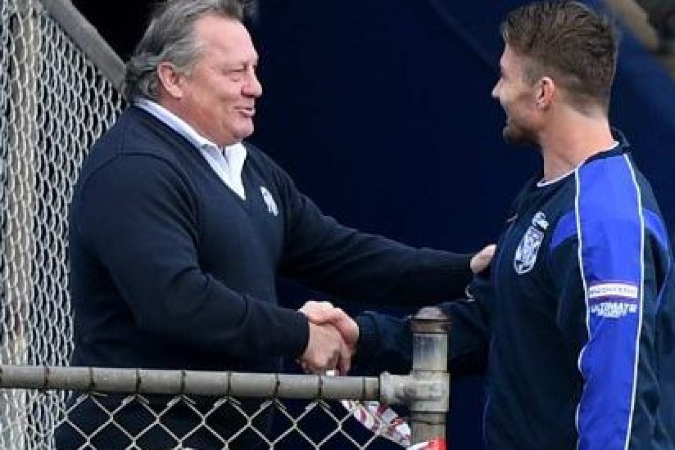 Terry Lamb gives the handshake that has landed the Bulldogs in hot water.
