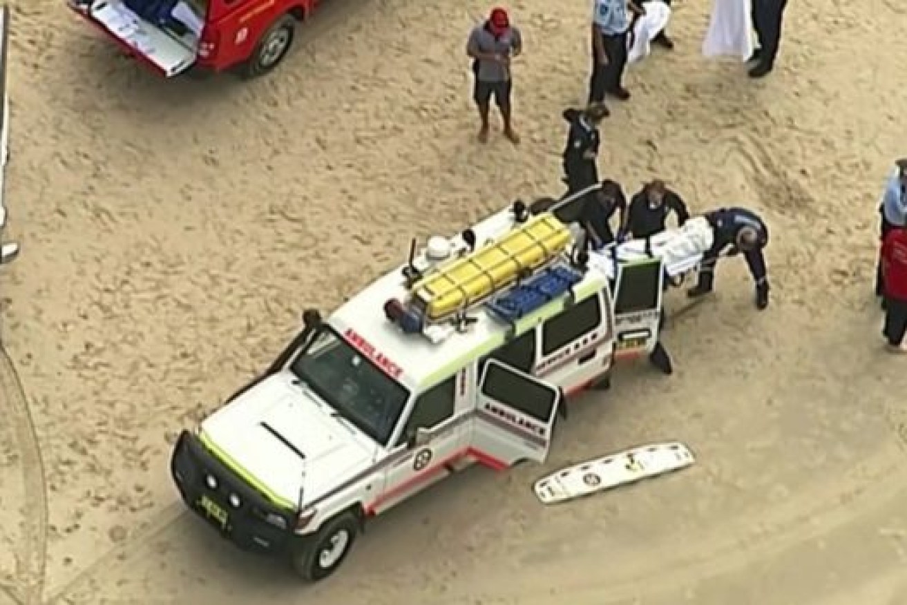 Emergency crews attend to shark attack victim Rob Pedretti.