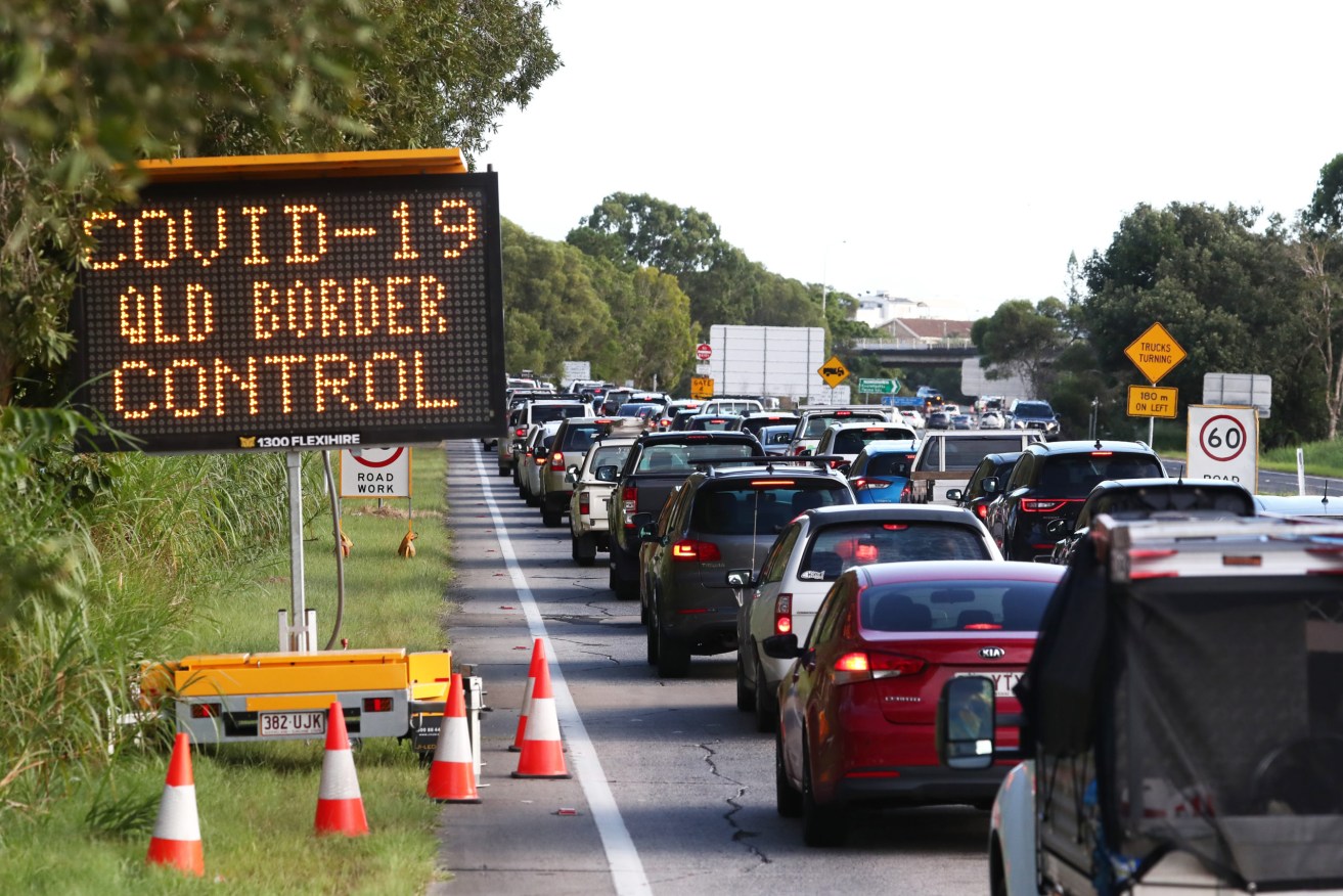 Traffic chaos at the Queensland border after the state welcomed tourists for the first time in four months (Photo: AAP Image/Jason O'Brien)