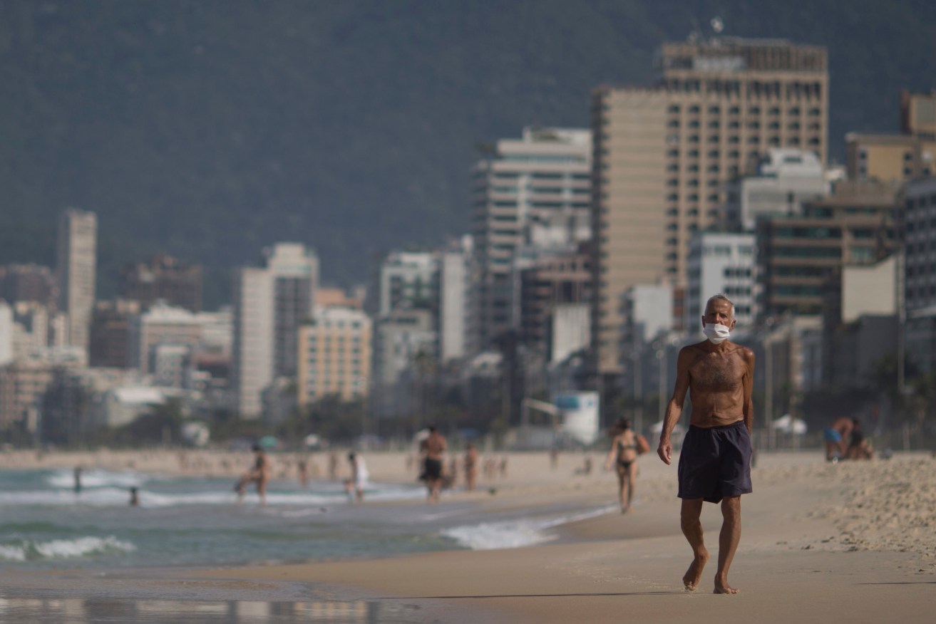 Bathers in the sand of Arpoador beach, Rio de Janeiro, where the local government allowed individual sports to be practiced and restricted bathers to remain on the beach sands. Photo: Fernando Souza / AGIF (via AP)