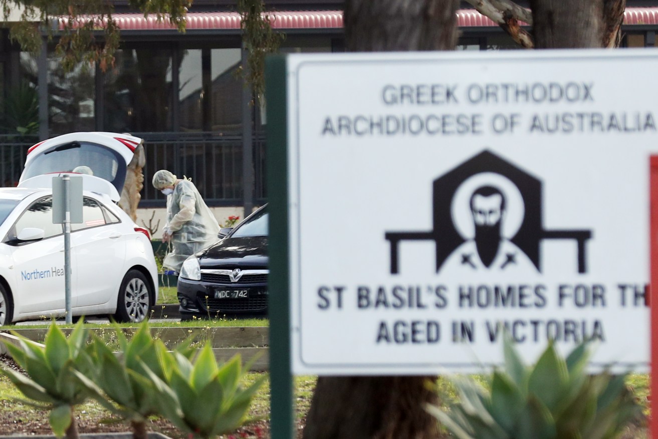 Medical staff are seen preparing to transport people from the St Basil’s Home for the Aged Care in Fawkner which has had an outbreak of COVID-19, Melbourne.  Aged care facilitates in Melbourne are being affected by the virus in multiple facilities. (Photo: AAP Image/David Crosling)