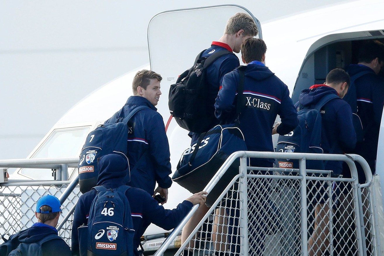 Western Bulldogs players board a flight for the Gold Coast on Monday. (Photo: AFL Photos)