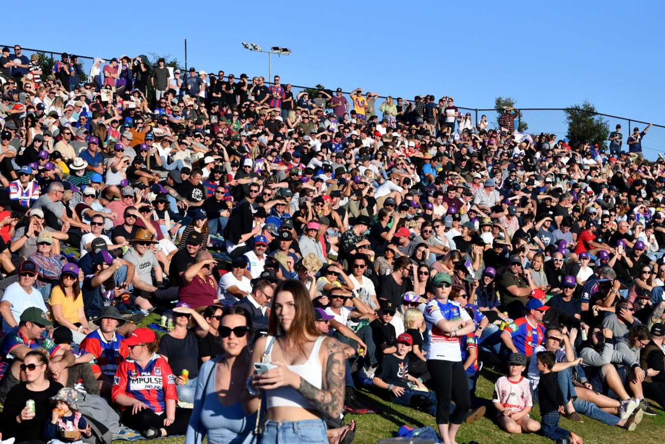 Crowds are seen on the hill during the Round 12 NRL match between the Melbourne Storm and Newcastle Knights at Sunshine Coast Stadium.  (Photo: AAP Image/Darren England) 