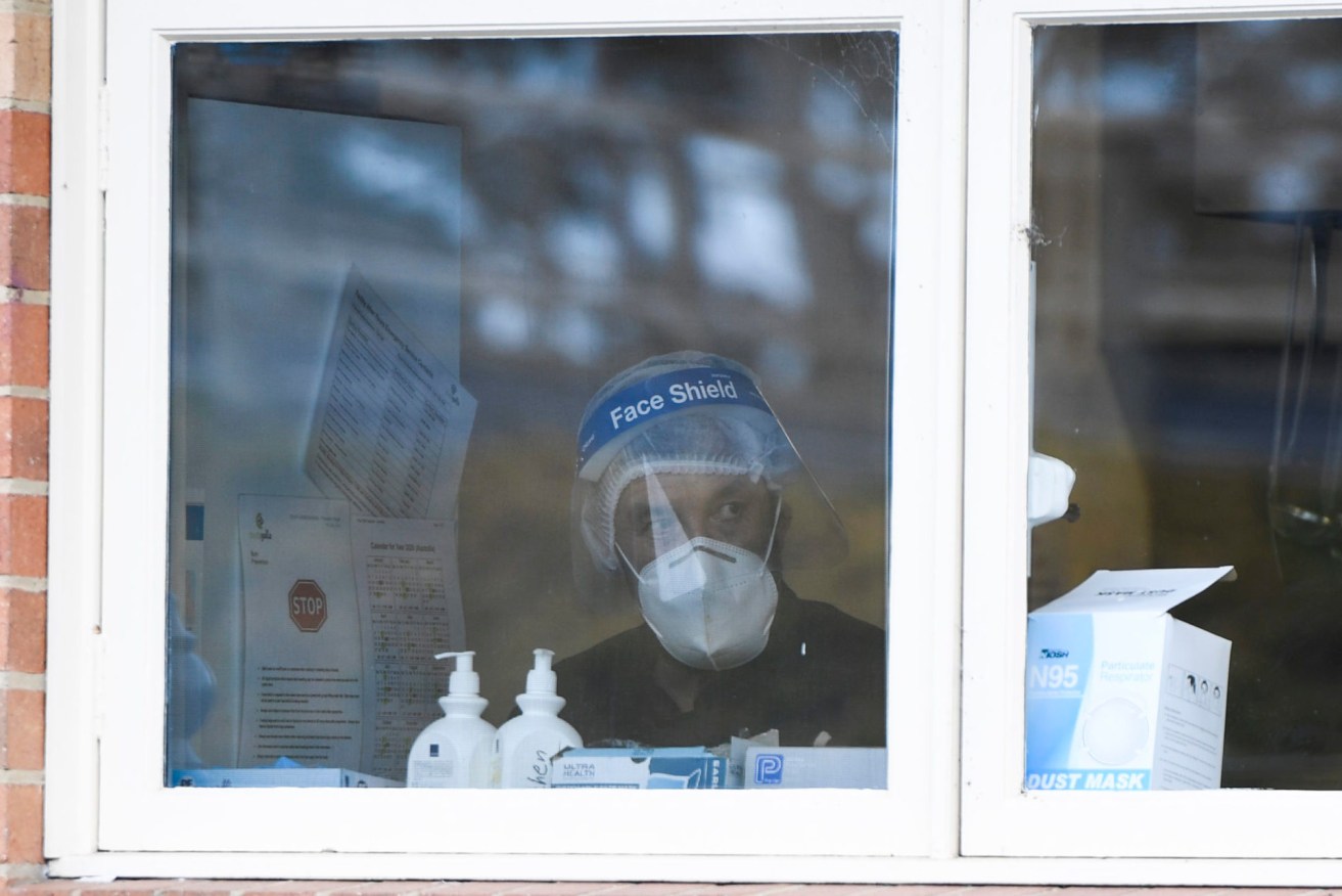 A worker wearing PPE is seen inside the Doutta Galla Yarraville Village in Melbourne on Sunday. (Photo: AAP Image/Erik Anderson)