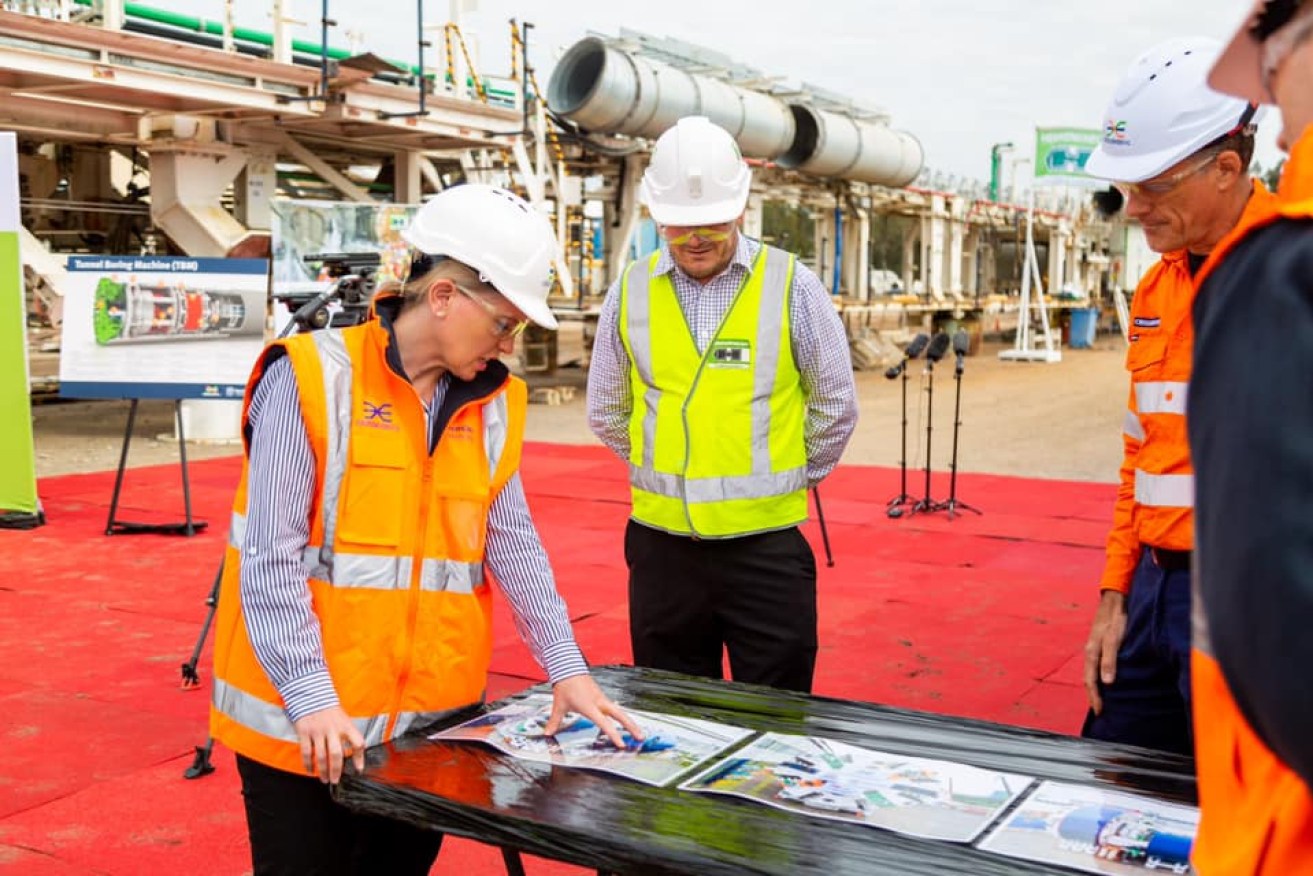 State Development Minister Kate Jones inspects the plans to put tunnel boring machines into service on Cross River Rail.