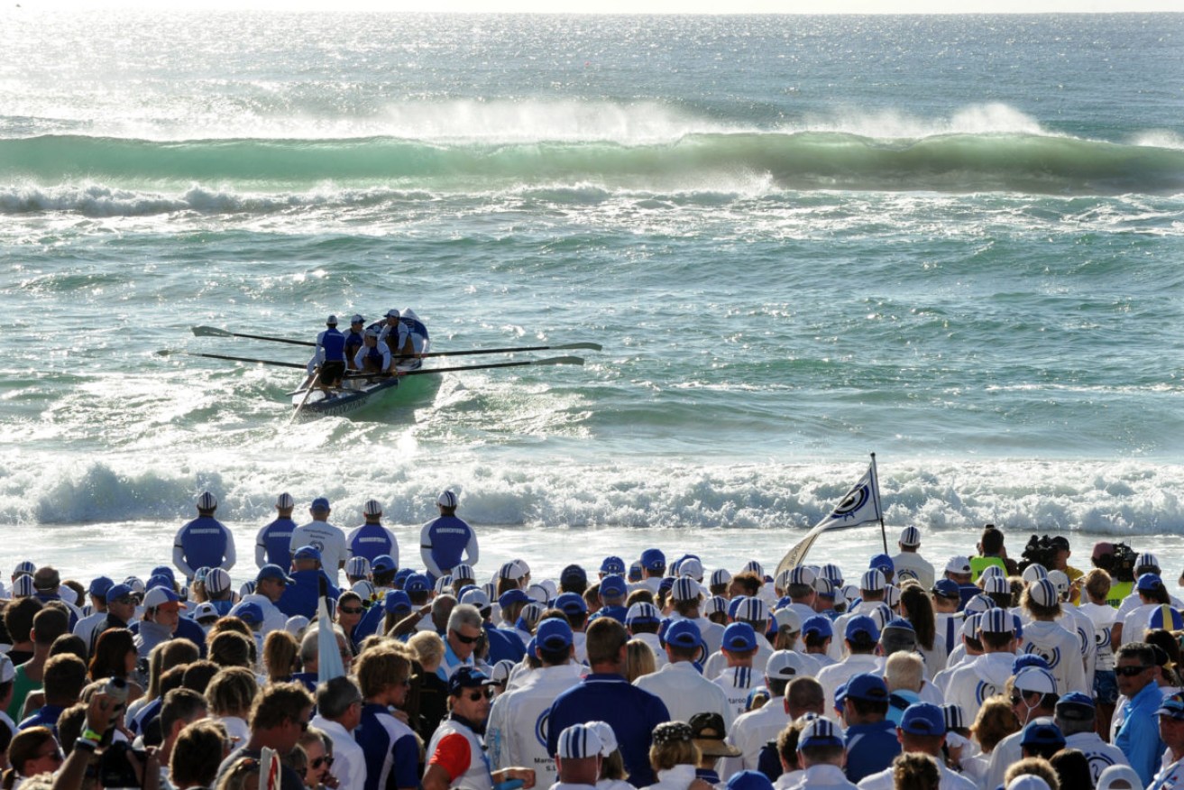 Maroochydore Surf Life Saving Club members row out to lay wreaths in the ocean during a memorial service for Matthew Barclay at Kurrawa Beach on the Gold Coast, Sunday, April 1, 2012. (Photo: AAP Image/Dave Hunt) 
