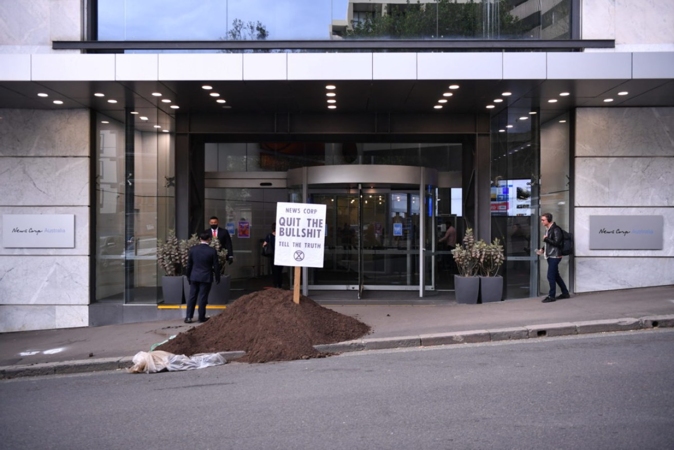 A pile of 'manure' was dumped outside the News Corp Australia offices in Sydney and Brisbane by Extinction Rebellion protesters. (AAP Image/Dean Lewins) 
