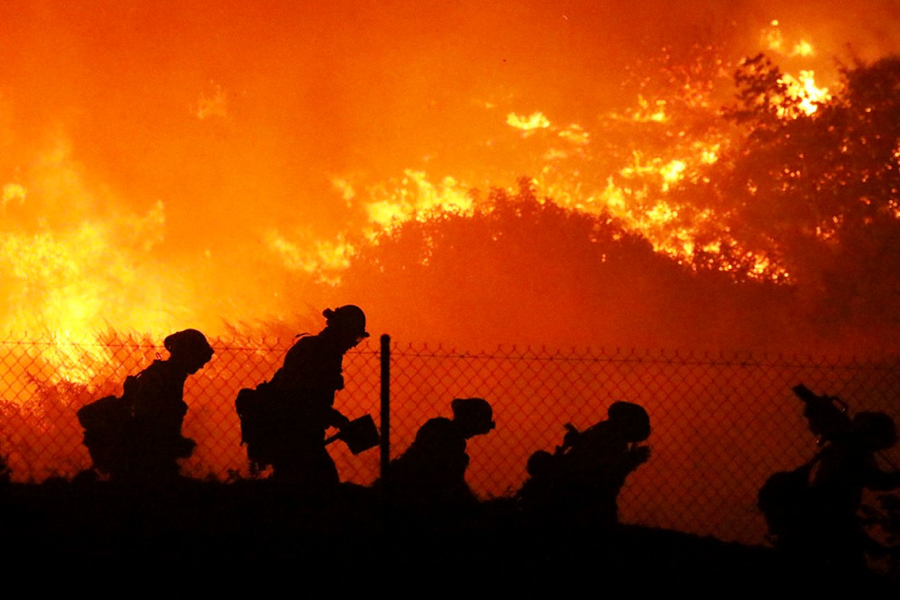 Firefighters battle wildfires in California. (Photo: AP Photo/David Swanson)