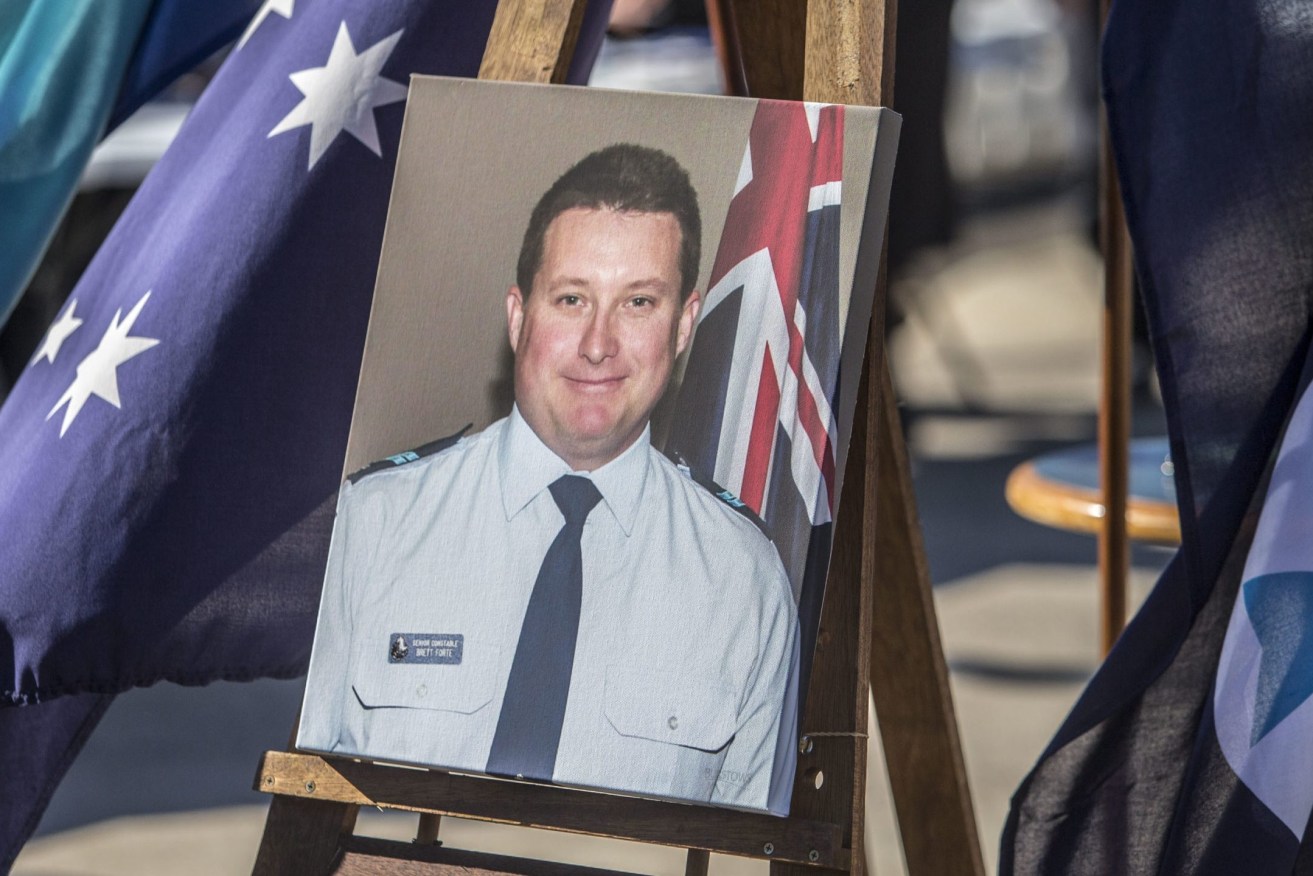A memorial photograph of Constable Brett Forte at his funeral in Toowoomba, in June 2017. (Photo: AAP Image/Glenn Hunt) 