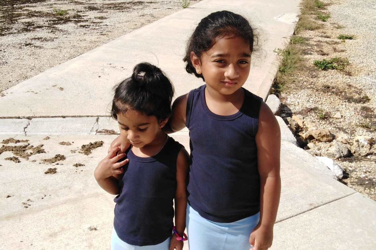 A supplied image shows Kopika (right) and Tharunicaa, the daughters of the Biloela Tamil family at the detention centre on Christmas Island.  (Photo: AAP Image/Supplied) 