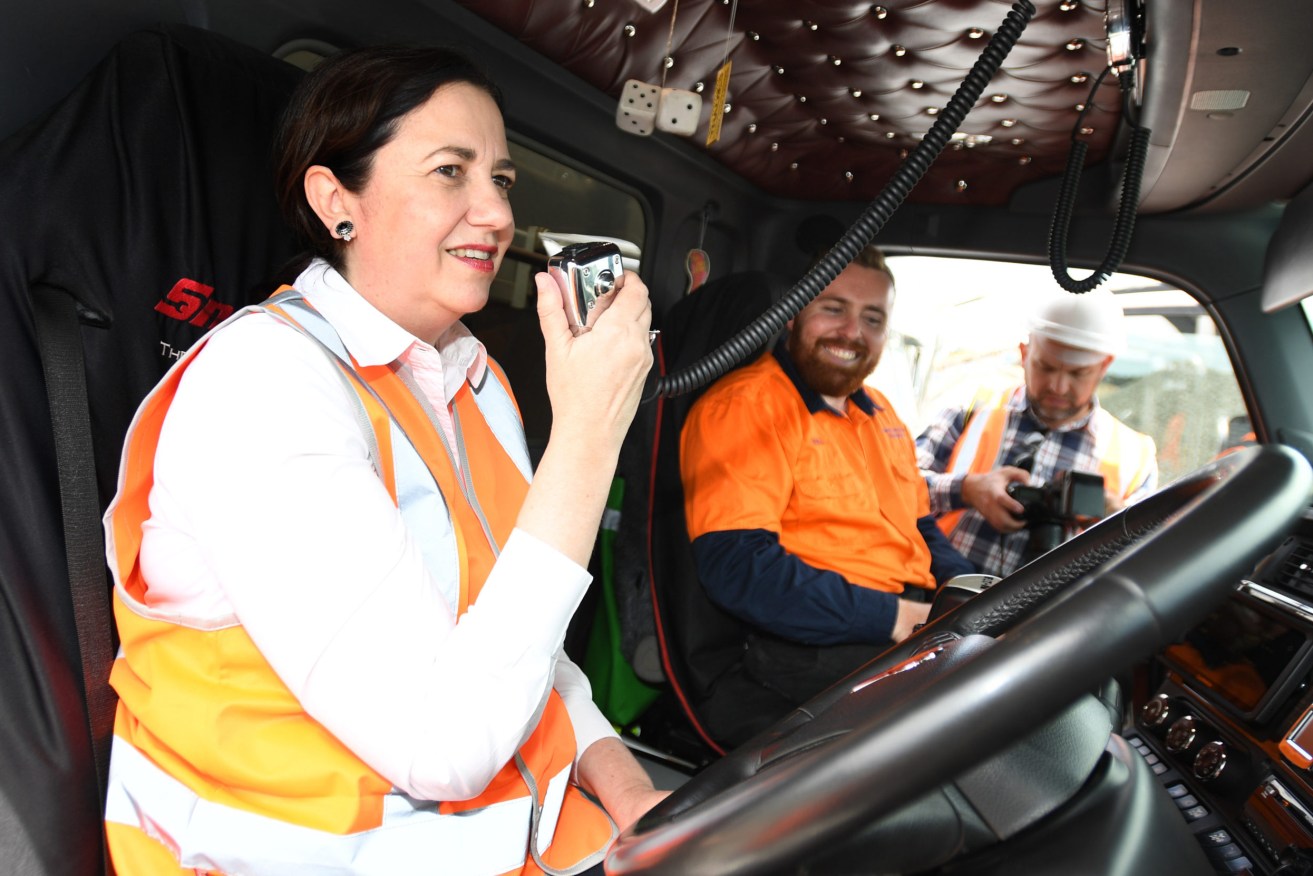 Queensland Premier Annastacia Palaszczuk sits in a truck while campaigning at Wholesale Sands and Recycling at Jacobs Well on the Gold Coast on Tuesday. (Photo: AAP Image/Dave Hunt) 