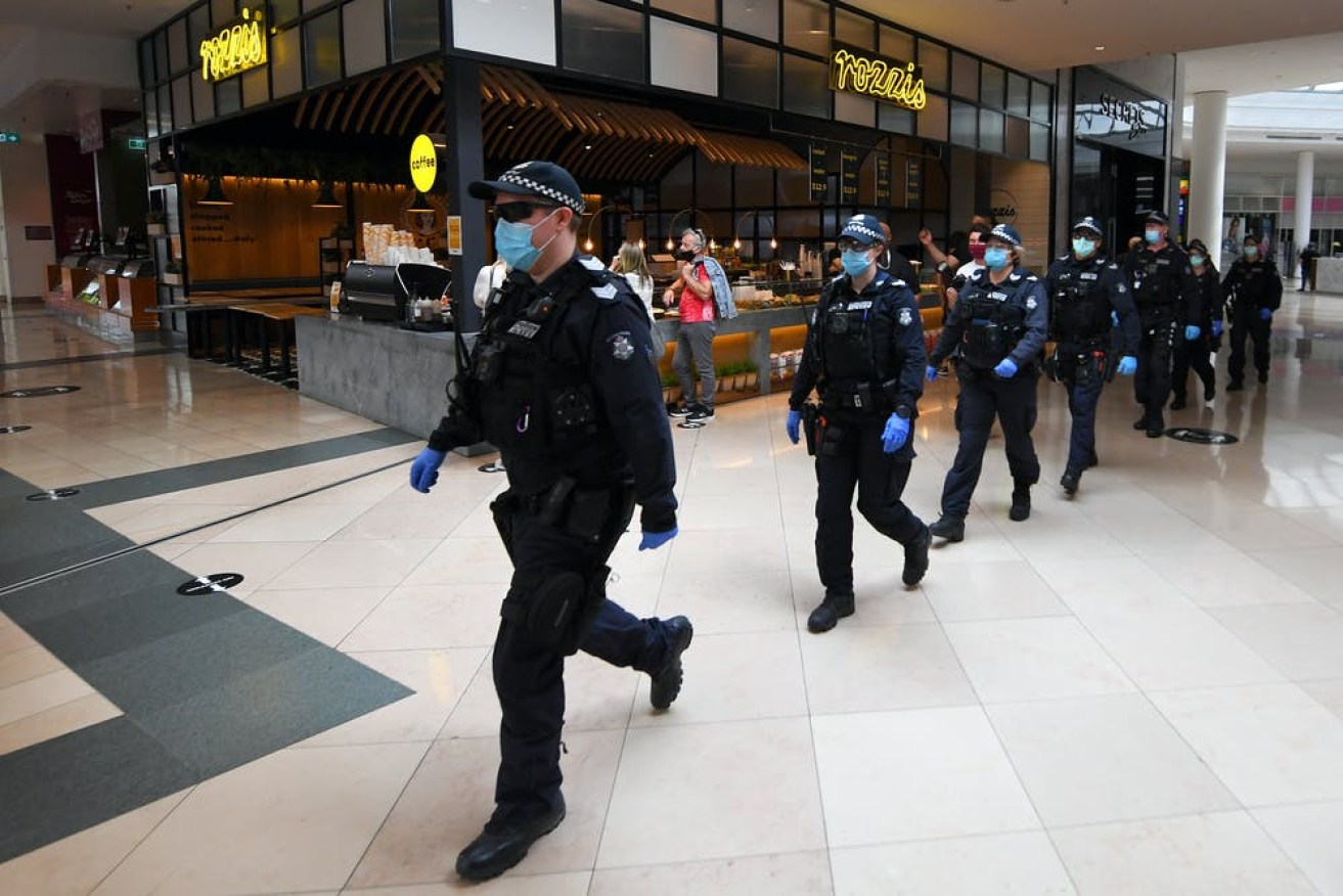 Victoria Police patrol through the Chadstone Shopping Centre in south-east Melbourne following an anti-lockdown protest on September 20, 2020. (Photo: James Ross/AAP)
