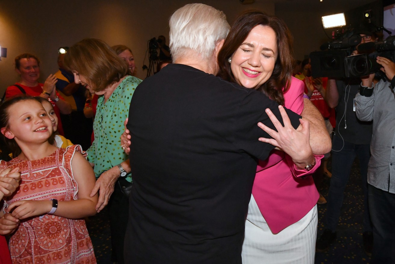 Queensland Premier Annastacia Palaszczuk (right) hugs her father Henry Palaszczuk after winning the Queensland State election at The Blue Fin Fishing Club r. (AAP Image/Darren England) 