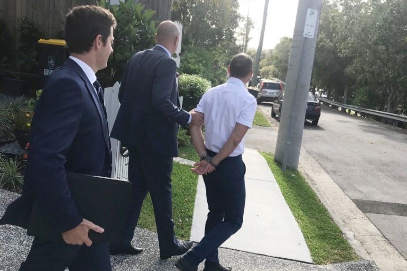 AFP officers arrested Russell Waugh from his Brisbane home on Wednesday before he was charged with foreign bribery.(Supplied: Australian Federal Police)