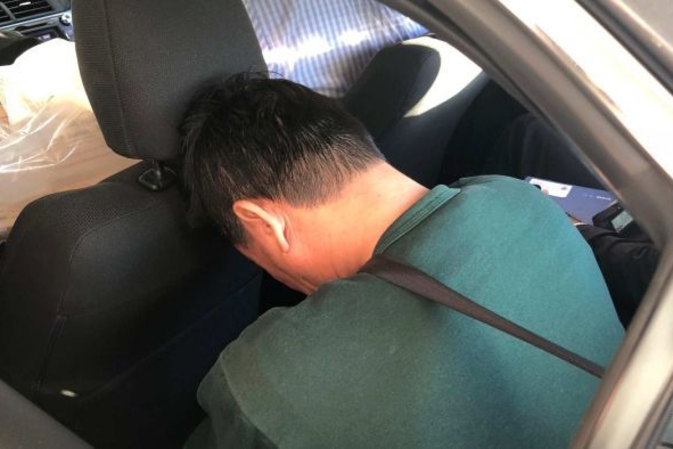 Zhen Jie Zhang in the custody of Queensland police following his arrest in May 2018. Photo: ABC