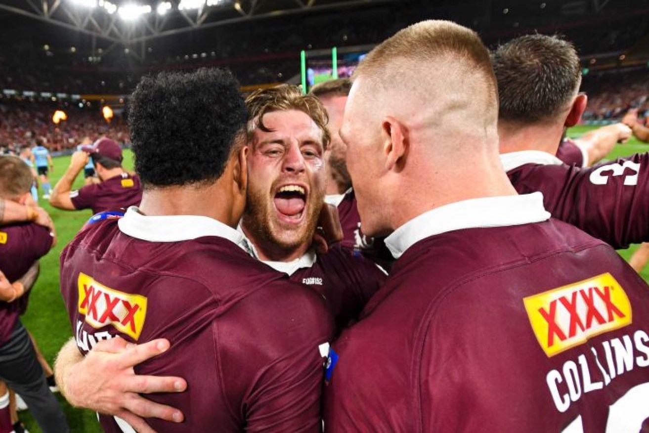 Man of the series Cameron Munster celebrates Wednesday's State of Origin victory with his team mates (ABC photo).