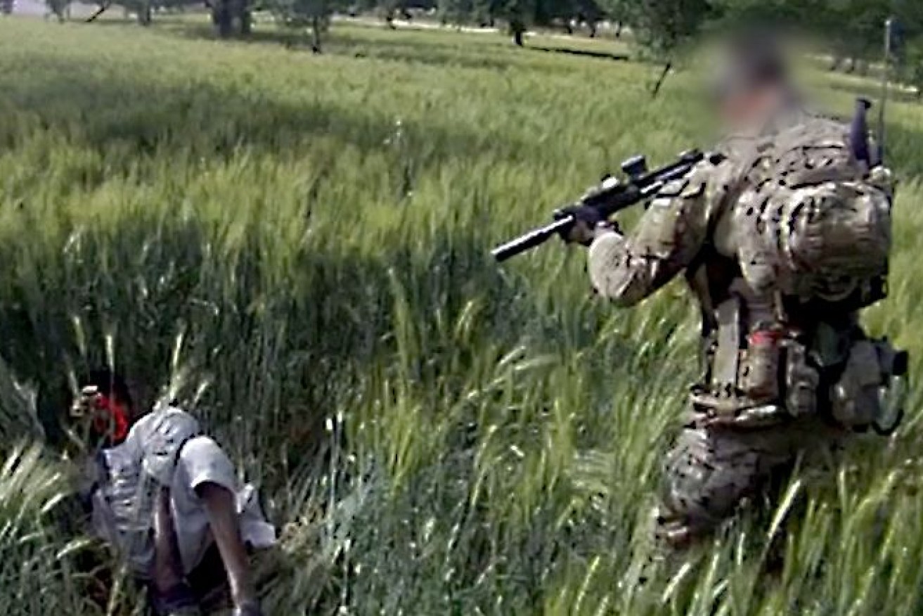 A still from alleged footage from a helmet camera showing an Australian soldier shooting dead an apparently unarmed Afghan man in a field in May 2012. ABC