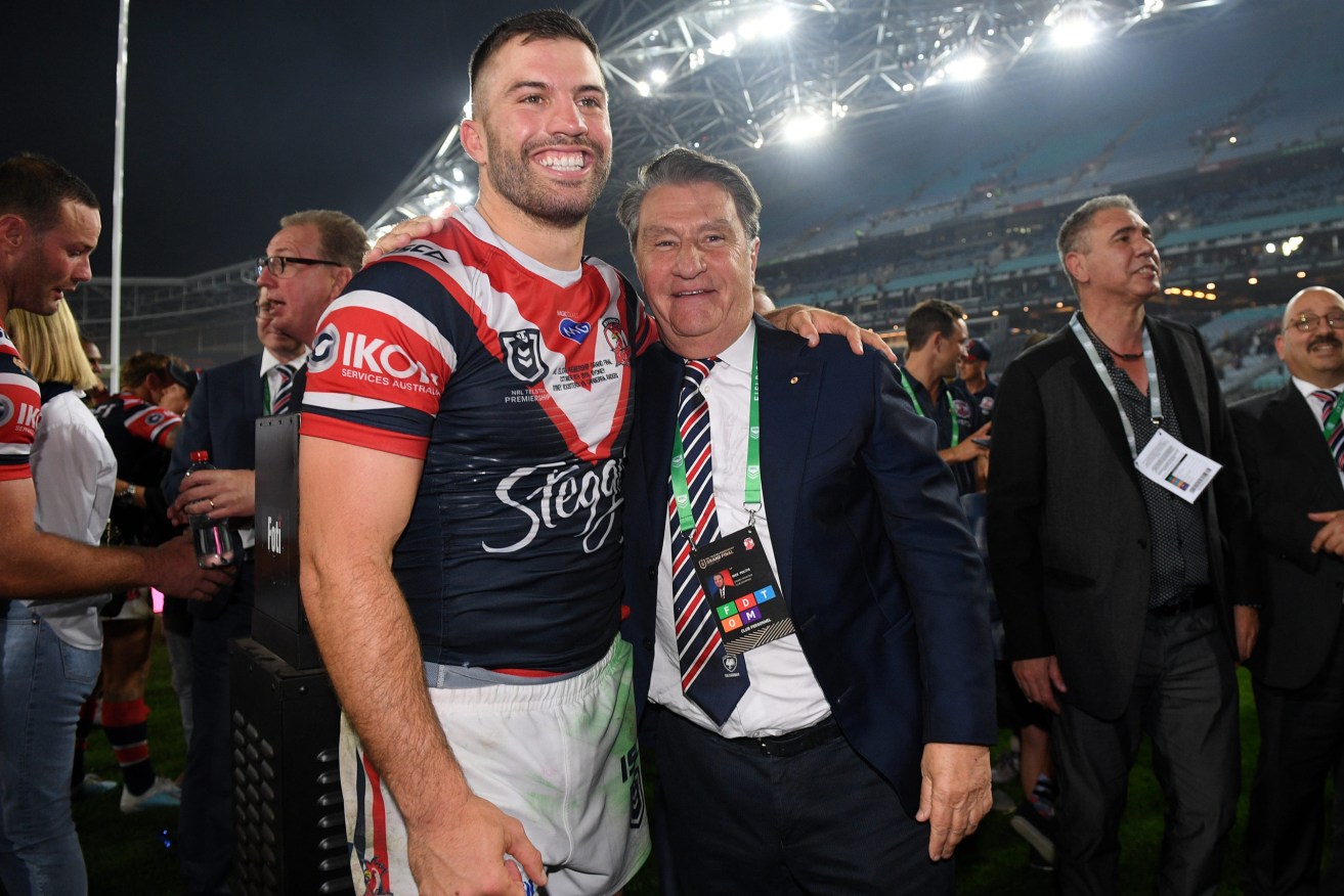 James Tedesco of the Roosters celebrates with Roosters Club Chairman Nick Politis following their win over the Raiders in the 2019 NRL Grand Final between the Canberra Raiders. (Photo: AAP Image/Dan Himbrechts) 