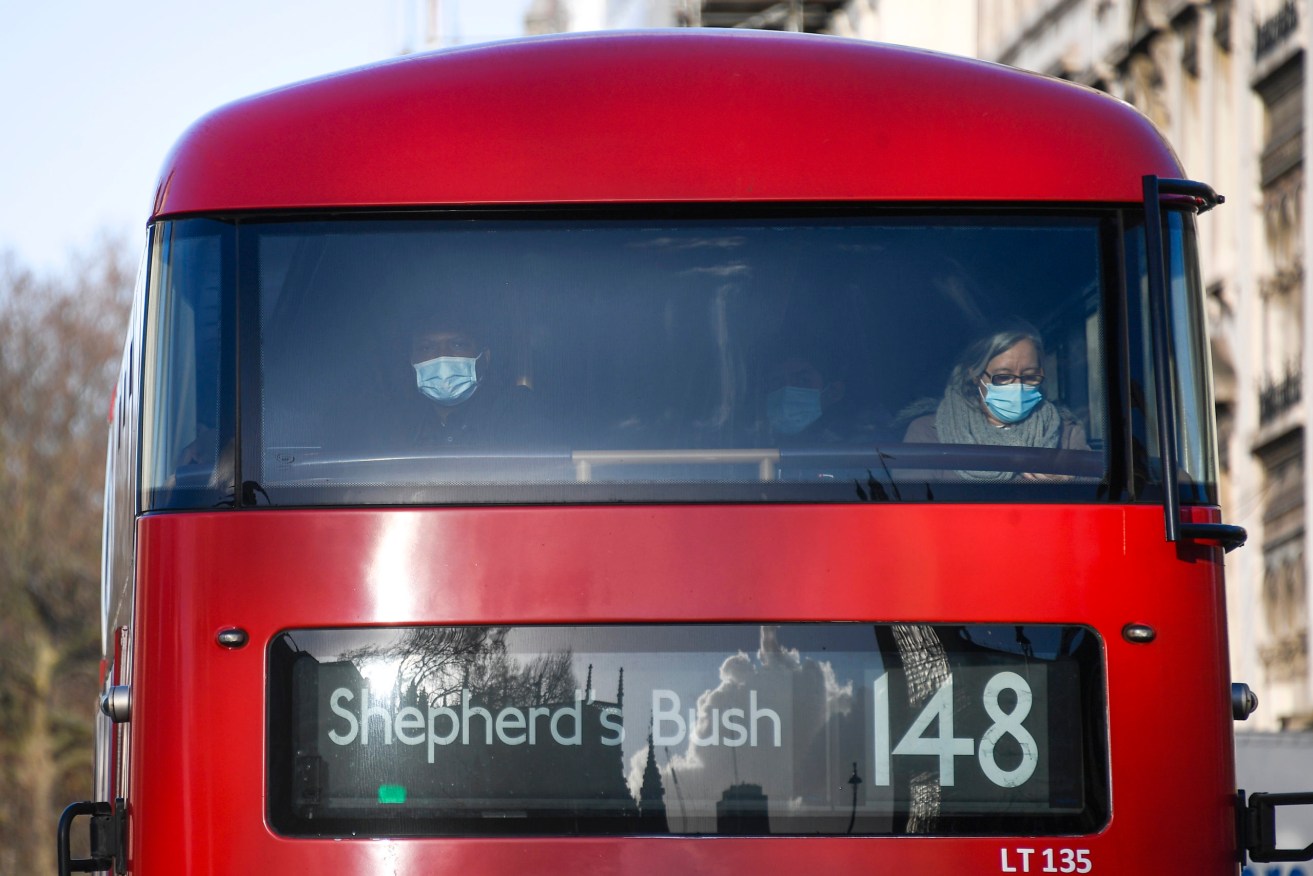 Passengers wear face masks as they sit on a double-decker bus, in London. (Photo: AP Photo/Alberto Pezzali)