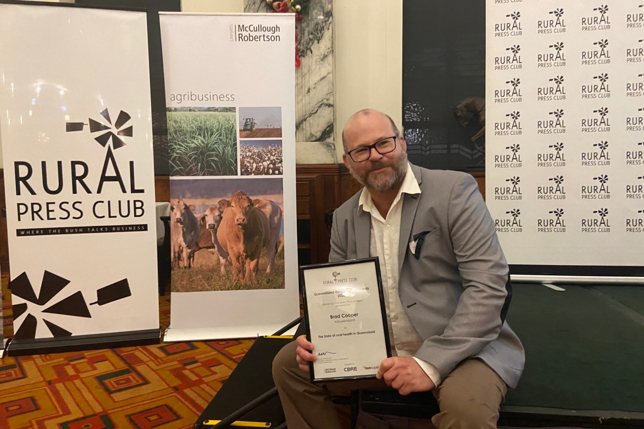 InQueensland regional specialist Brad Cooper with his Queensland Rural Media Award.