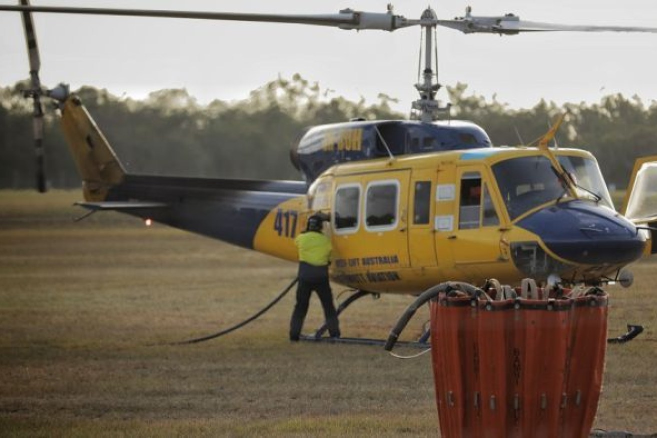 Helilift Australia (McDermott Aviation) water dumping chopper 417 refuels at Hervey Bay Airport to assist with the Fraser Island bushfire. (Photo: ABC)