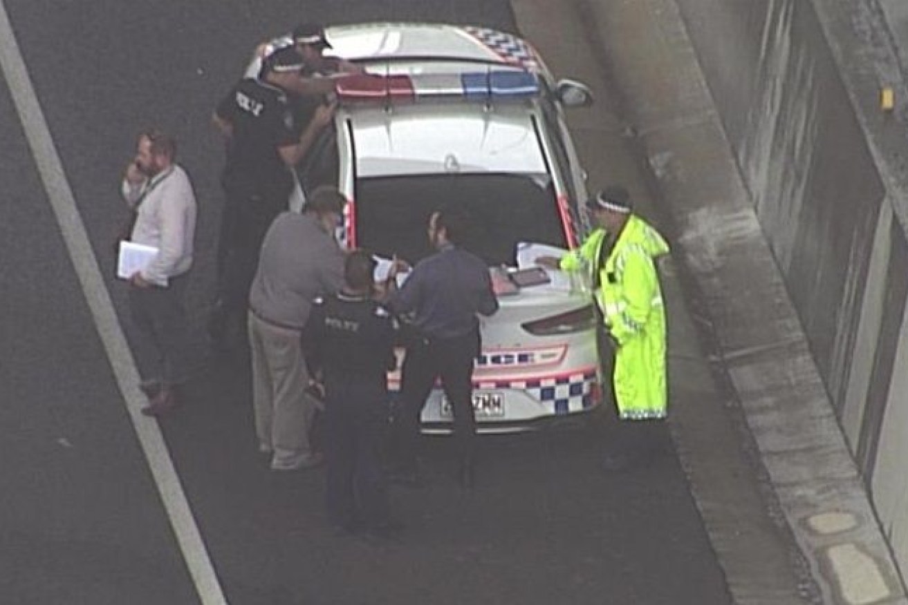 Police at the scene of this morning's shooting on the Logan Motorway after an armed man confronted officers. (Photo: ABC)