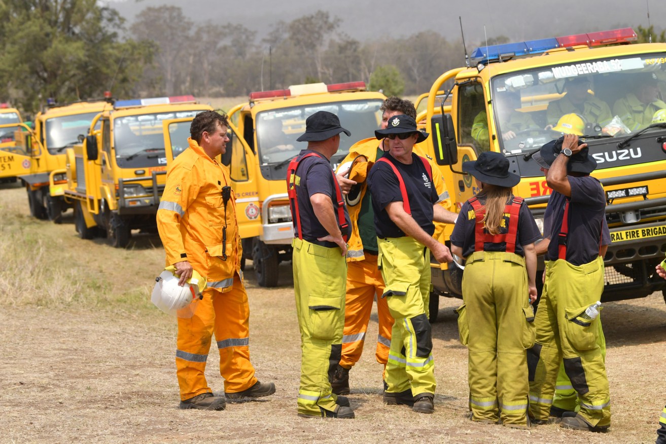 Rural firefighters are seen preparing to fight fires at Spicers Gap, south west of Brisbane, in November 2019 as bushfires began to rage out of control..  (AAP Image/Darren England)
