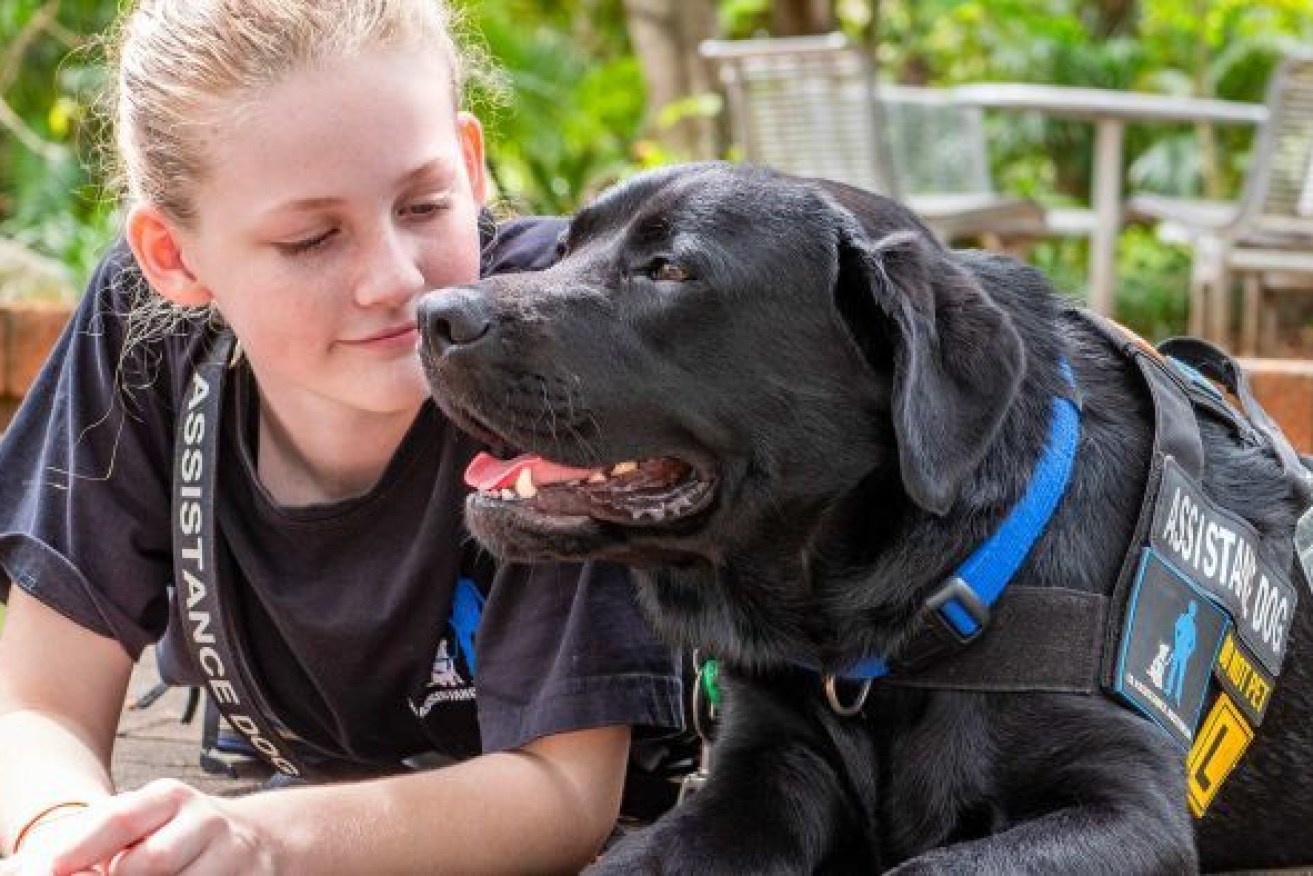 Summer Farrelly and her assistance dog Onyx, who she describes as a "friend and an anchor". Photo: ABC