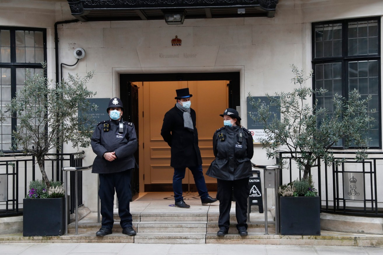 Police stand guard outside the King Edward VII hospital In London, where Britain's Prince Philip is being treated. (AP Photo/Alastair Grant)