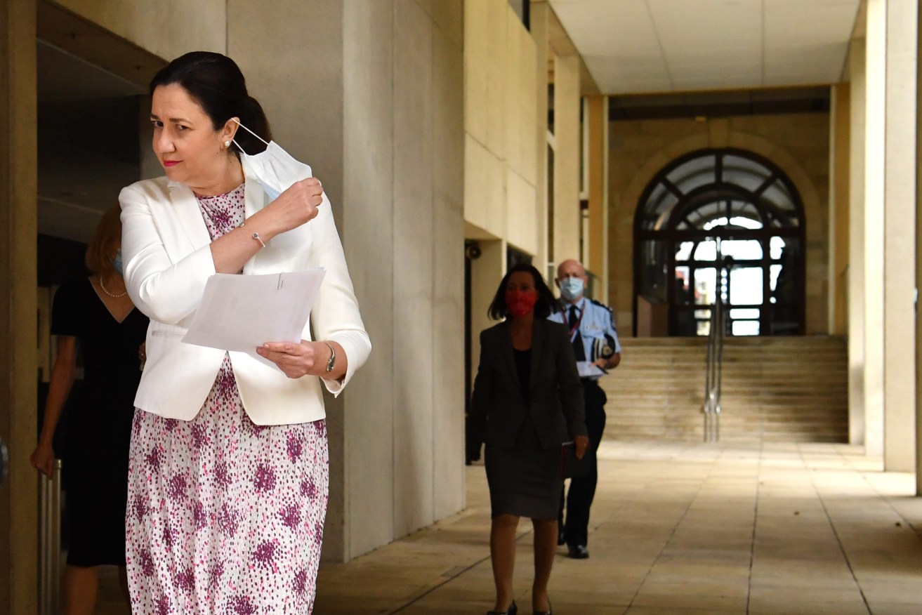 Queensland Premier Annastacia Palaszczuk (left) is seen arriving for a press conference to confirm 10 new cases of COVID-19 in Queensland. (AAP Image/Darren England) 