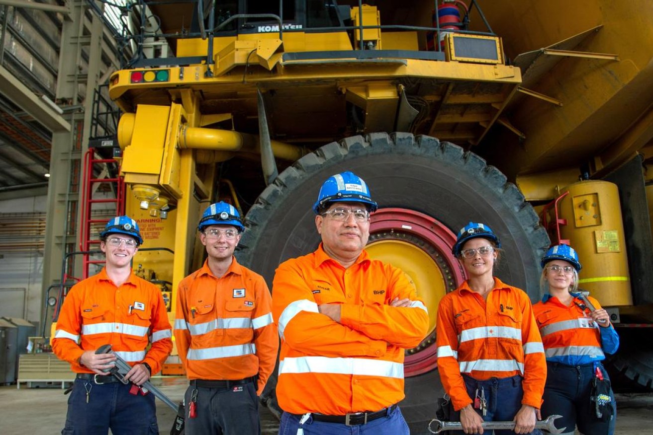 BHP minerals Australia president Edgar Basto with workers Photo: BHP).