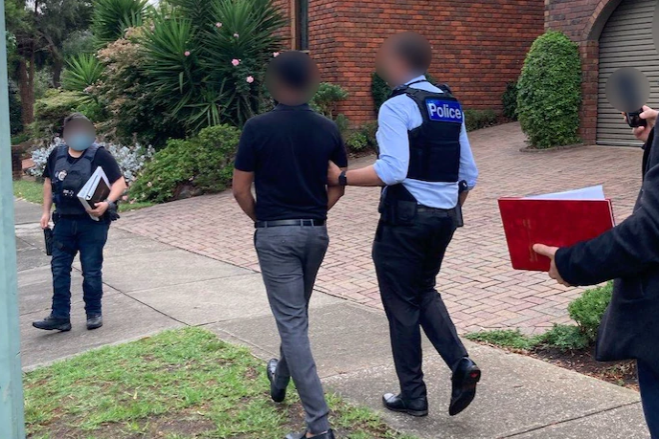 A Brisbane man is arrested by Federal Police after raids in Brisbane and Melbourne (Pic: ABC)