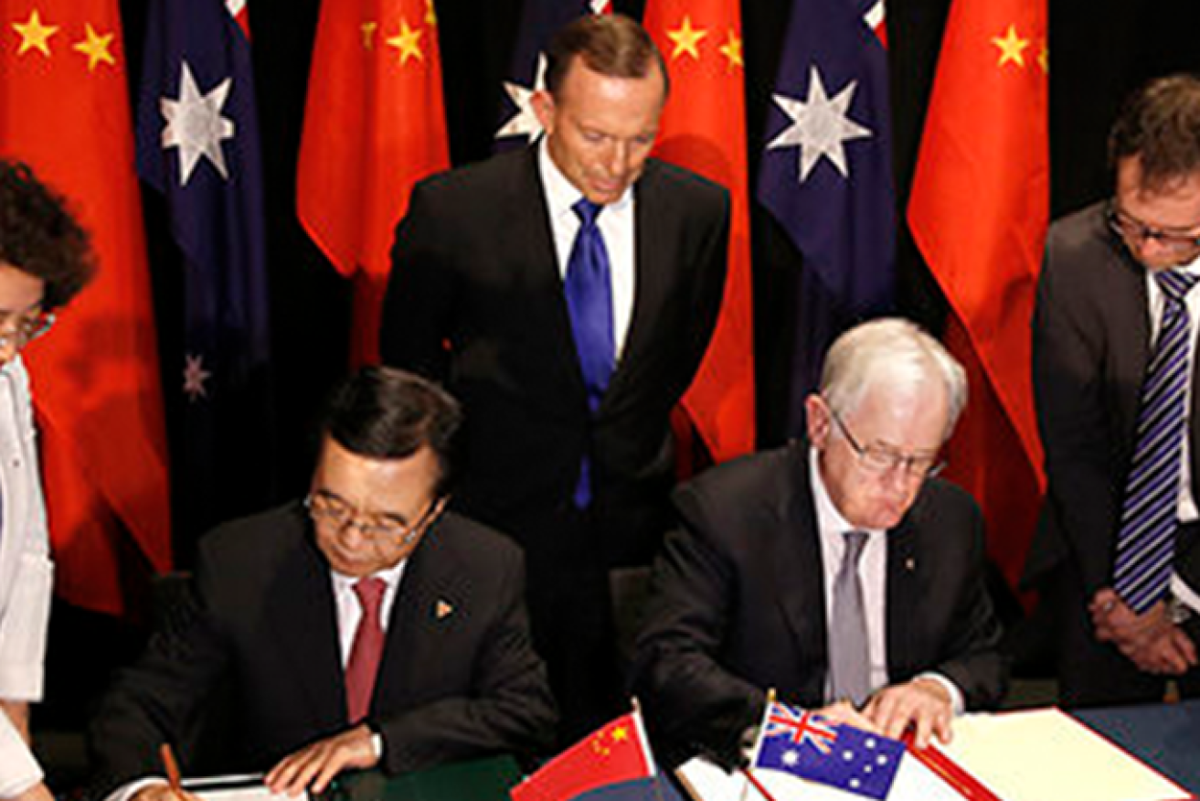 In 2015, Australia's Trade and Investment Minister Andrew Robb and Chinese Commerce Minister Gao Hucheng signed the China-Australia Free Trade Agreement in Canberra, as Prime Minister Tony Abbott looked on. (Image: Supplied)
