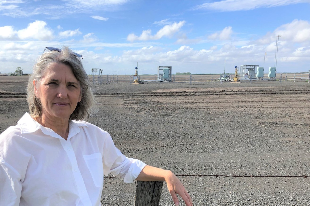 Dalby cotton grower Zena Ronnfeldt with CSG wells in the background.