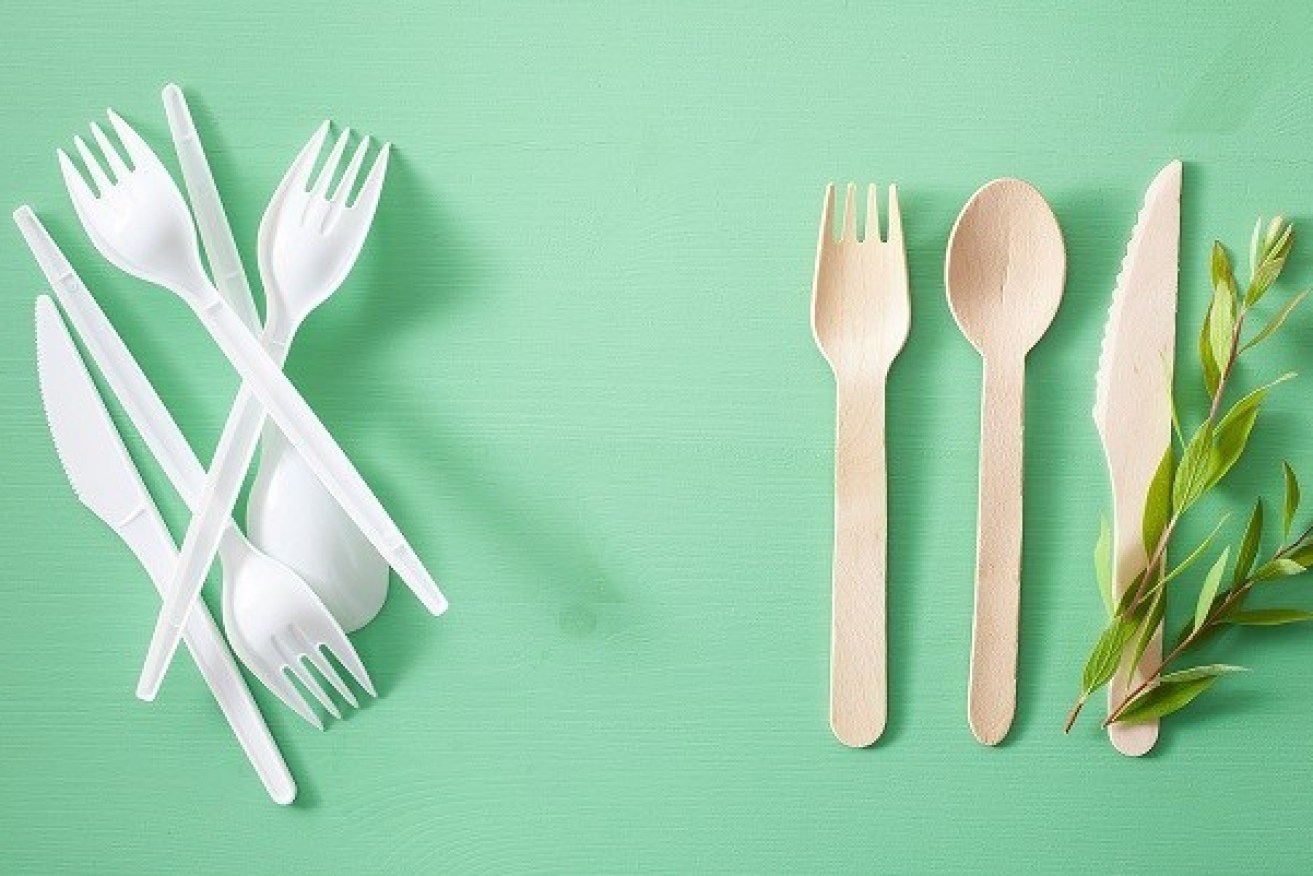 harmful plastic and eco friendly wooden cutlery. plastic free concept
